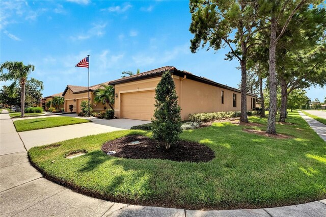 view of side of home featuring a garage and a yard