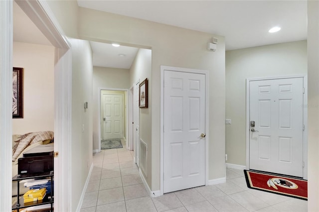 hall with light tile patterned floors