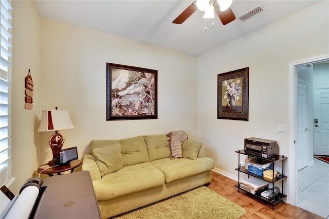 living room featuring ceiling fan and light parquet flooring