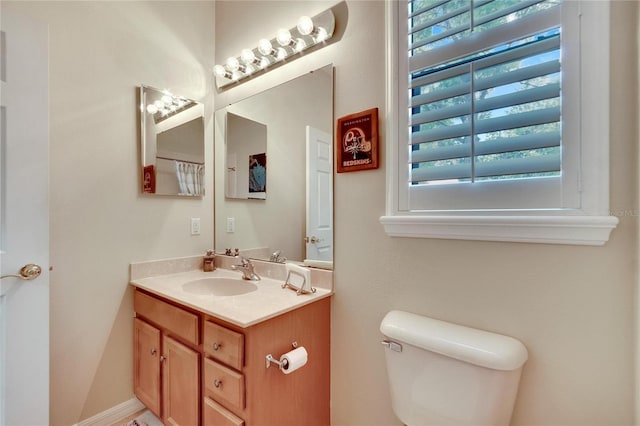 bathroom featuring toilet and vanity
