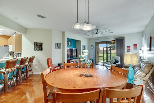 dining space featuring ceiling fan and light wood-type flooring