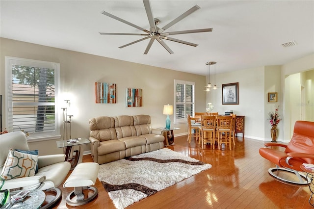 living room with ceiling fan, hardwood / wood-style floors, and a healthy amount of sunlight