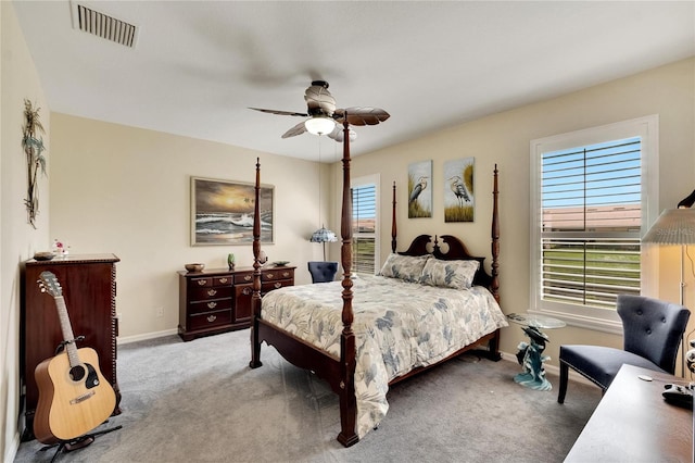 carpeted bedroom featuring baseboards, ceiling fan, and visible vents