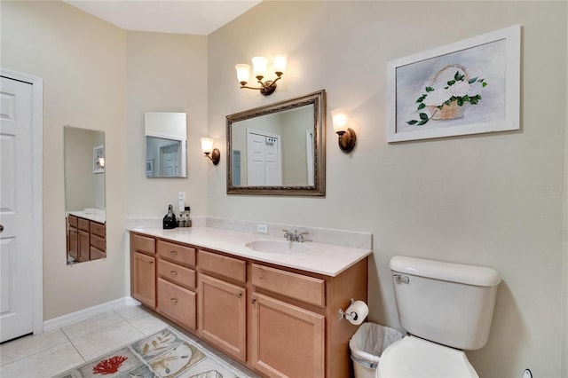 bathroom with toilet, tile patterned flooring, and vanity