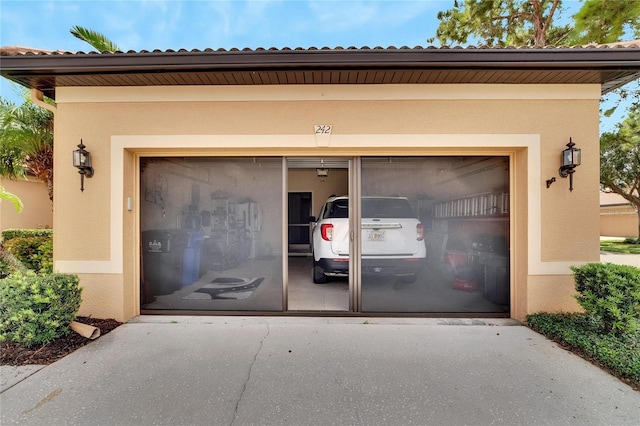 garage featuring concrete driveway