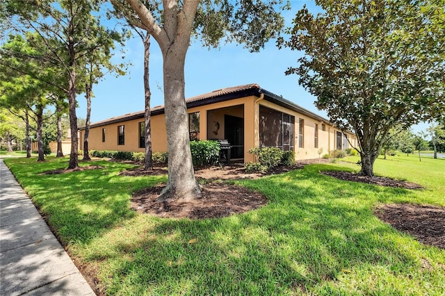 view of front of home featuring a front lawn and stucco siding