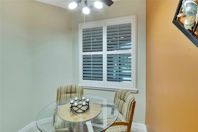 tiled dining area featuring ceiling fan