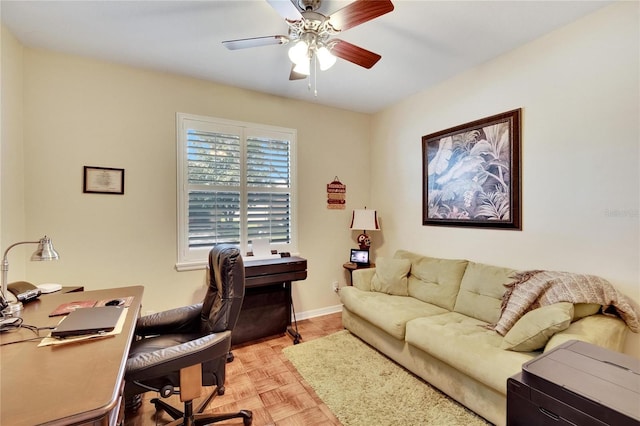 office space with light parquet floors and ceiling fan