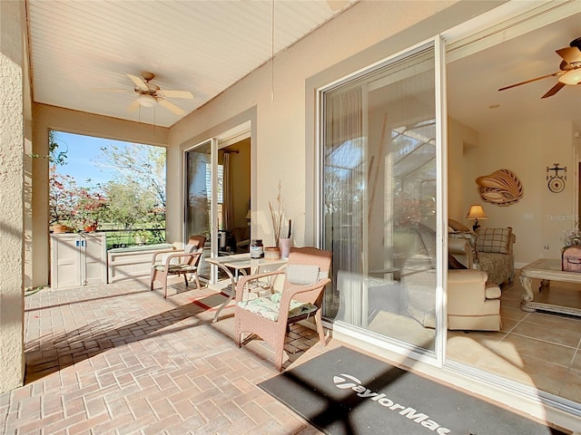 sunroom featuring ceiling fan