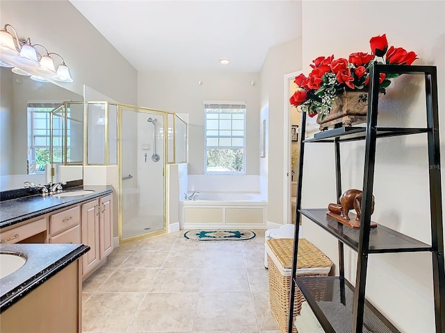 bathroom featuring tile patterned flooring, vanity, and shower with separate bathtub