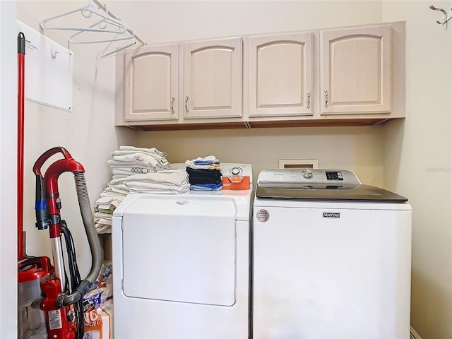 laundry area with cabinets and washing machine and dryer