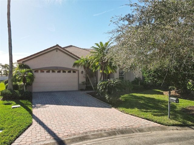 view of front of property with a front yard and a garage