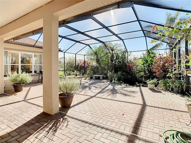 view of patio with glass enclosure