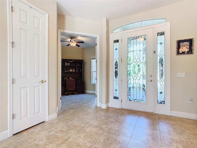 tiled foyer featuring ceiling fan