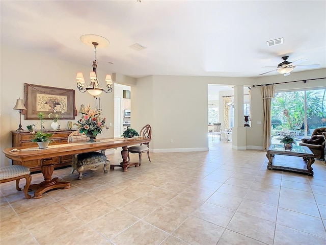 dining space featuring ceiling fan with notable chandelier and light tile patterned floors