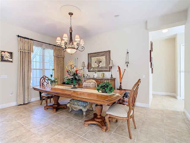 tiled dining room with a notable chandelier