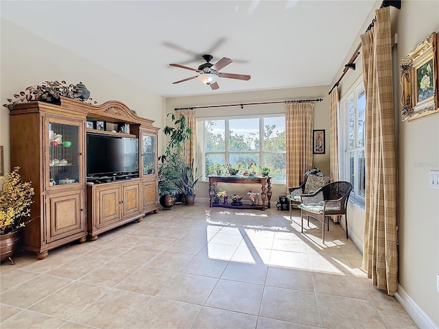 tiled living room with ceiling fan