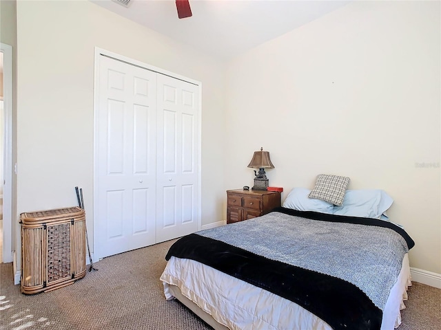 carpeted bedroom featuring ceiling fan and a closet