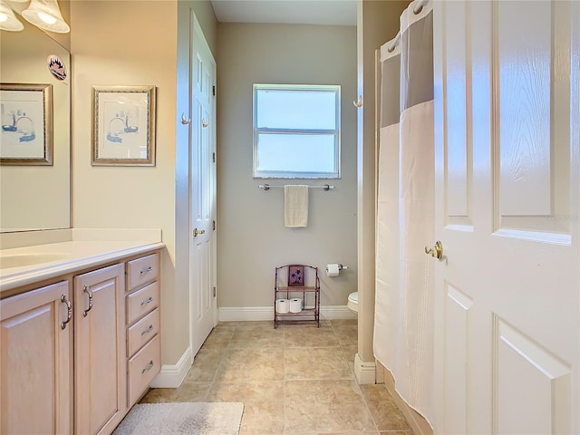 bathroom with vanity and toilet