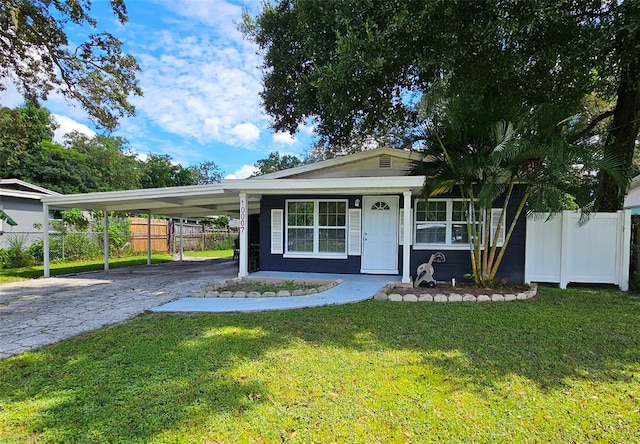 ranch-style house featuring a front lawn and a carport