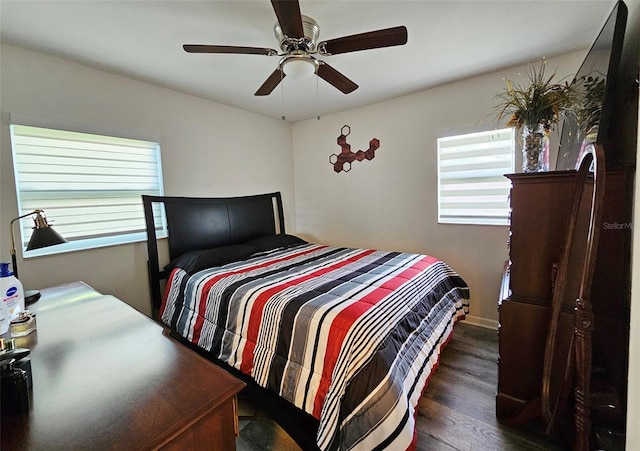 bedroom with ceiling fan and dark hardwood / wood-style flooring