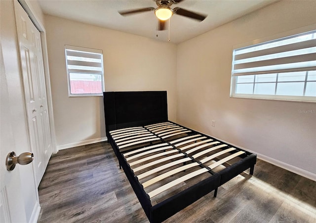 unfurnished bedroom featuring a closet, ceiling fan, and dark hardwood / wood-style flooring