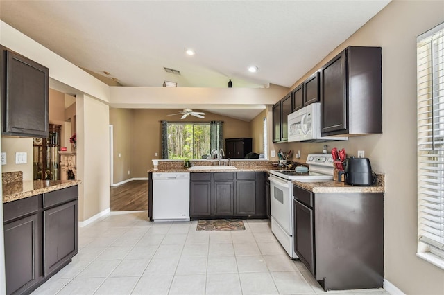 kitchen featuring white appliances, kitchen peninsula, lofted ceiling, ceiling fan, and sink