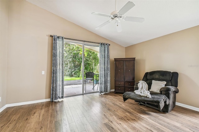 living area with light hardwood / wood-style floors, lofted ceiling, and ceiling fan