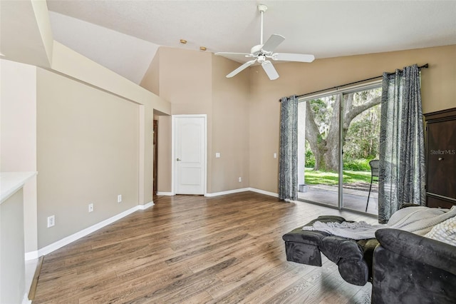 living room featuring high vaulted ceiling, ceiling fan, and hardwood / wood-style flooring