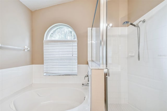 bathroom featuring shower with separate bathtub