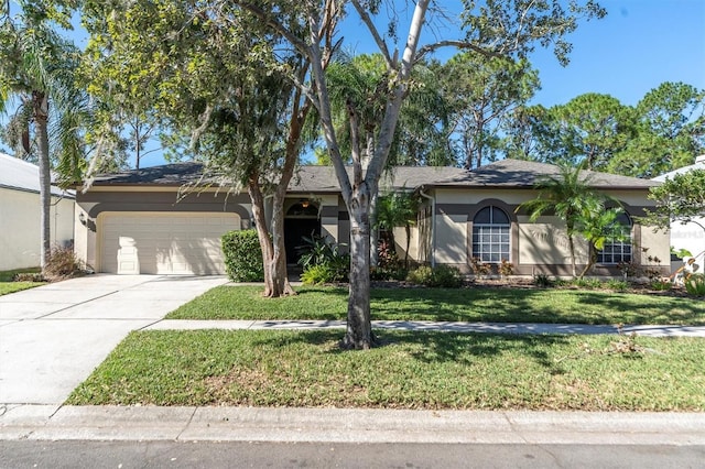 view of front of home featuring a front yard and a garage