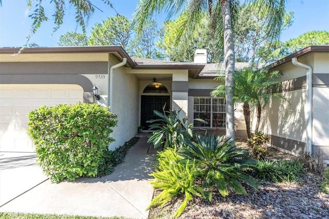 doorway to property with a garage