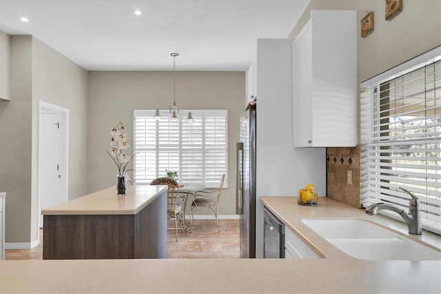 kitchen with white cabinets, dark brown cabinets, sink, pendant lighting, and stainless steel appliances