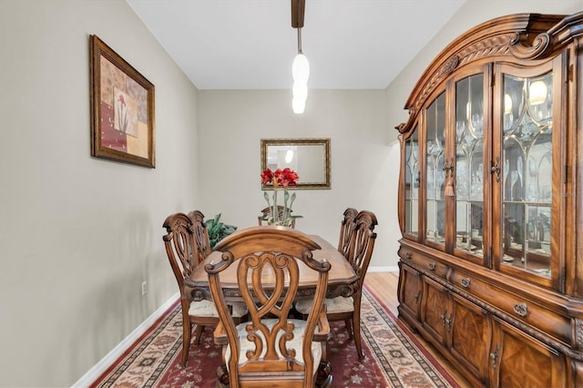 dining space with dark hardwood / wood-style floors