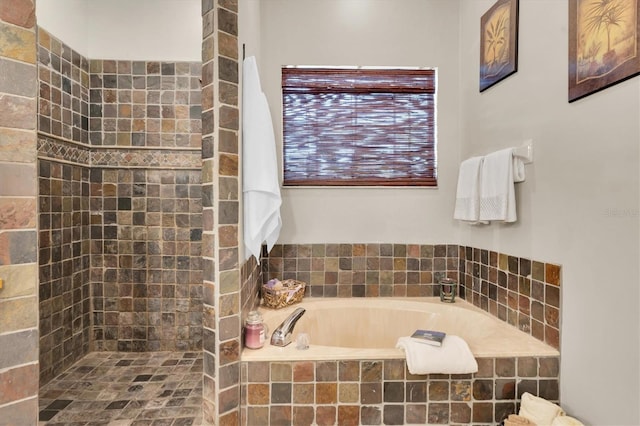 bathroom featuring separate shower and tub