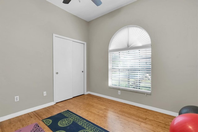 living area with hardwood / wood-style floors and ceiling fan