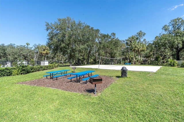 view of property's community with a yard and volleyball court