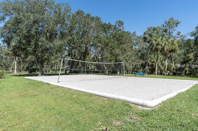 view of property's community with a yard and volleyball court