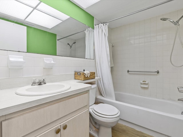 full bathroom featuring vanity, toilet, shower / bathtub combination with curtain, and backsplash