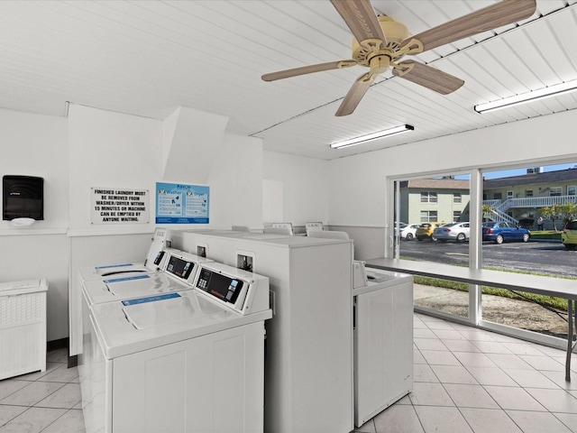 laundry room with ceiling fan, light tile patterned floors, and washer and clothes dryer