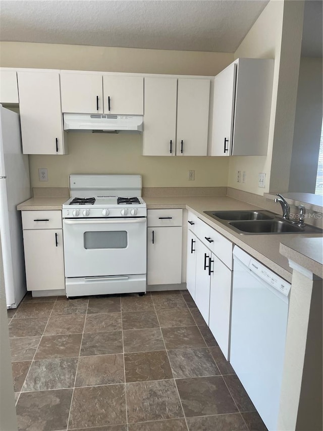 kitchen featuring white appliances, white cabinets, sink, and a textured ceiling