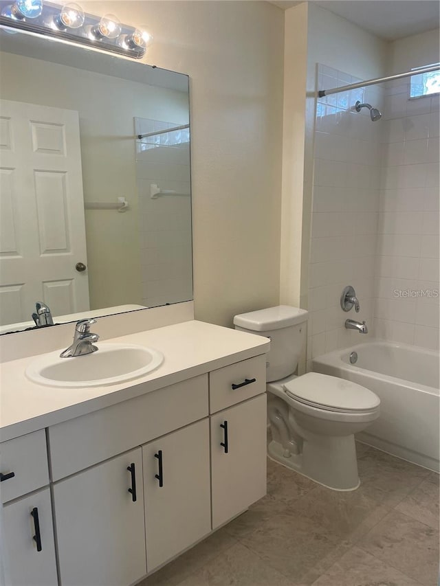 full bathroom with tiled shower / bath combo, vanity, and toilet