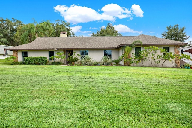 single story home featuring a front lawn