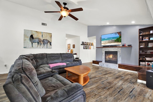 living room with wood-type flooring, vaulted ceiling, and ceiling fan