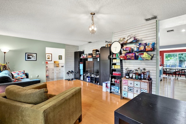 living room featuring hardwood / wood-style floors and a textured ceiling