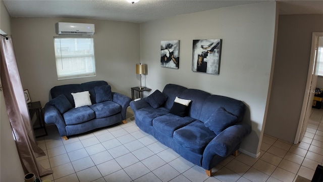 living room with a textured ceiling, light tile patterned floors, and a wall unit AC