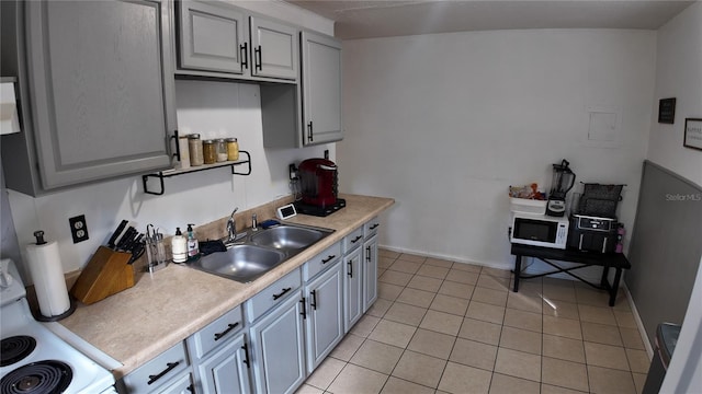 kitchen featuring gray cabinets, white appliances, and light tile patterned floors