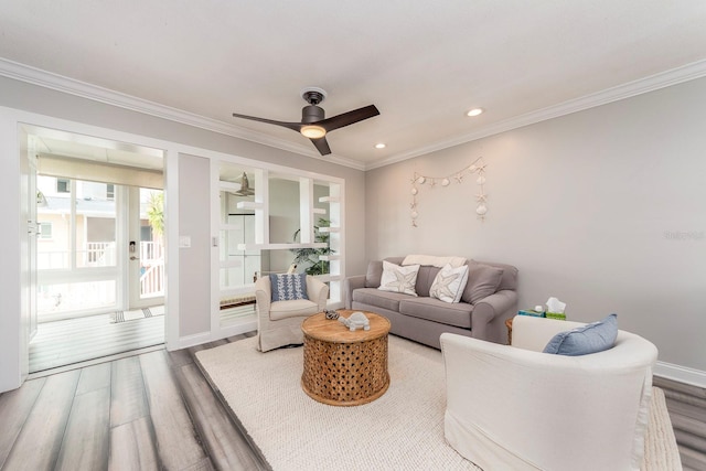 living room featuring ceiling fan, crown molding, and hardwood / wood-style floors