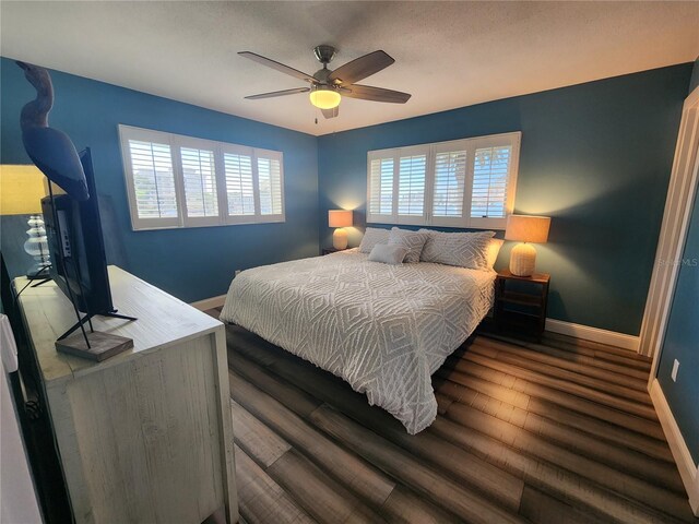 bedroom with ceiling fan and dark hardwood / wood-style flooring