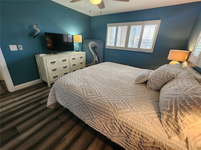 bedroom with dark wood-type flooring and ceiling fan